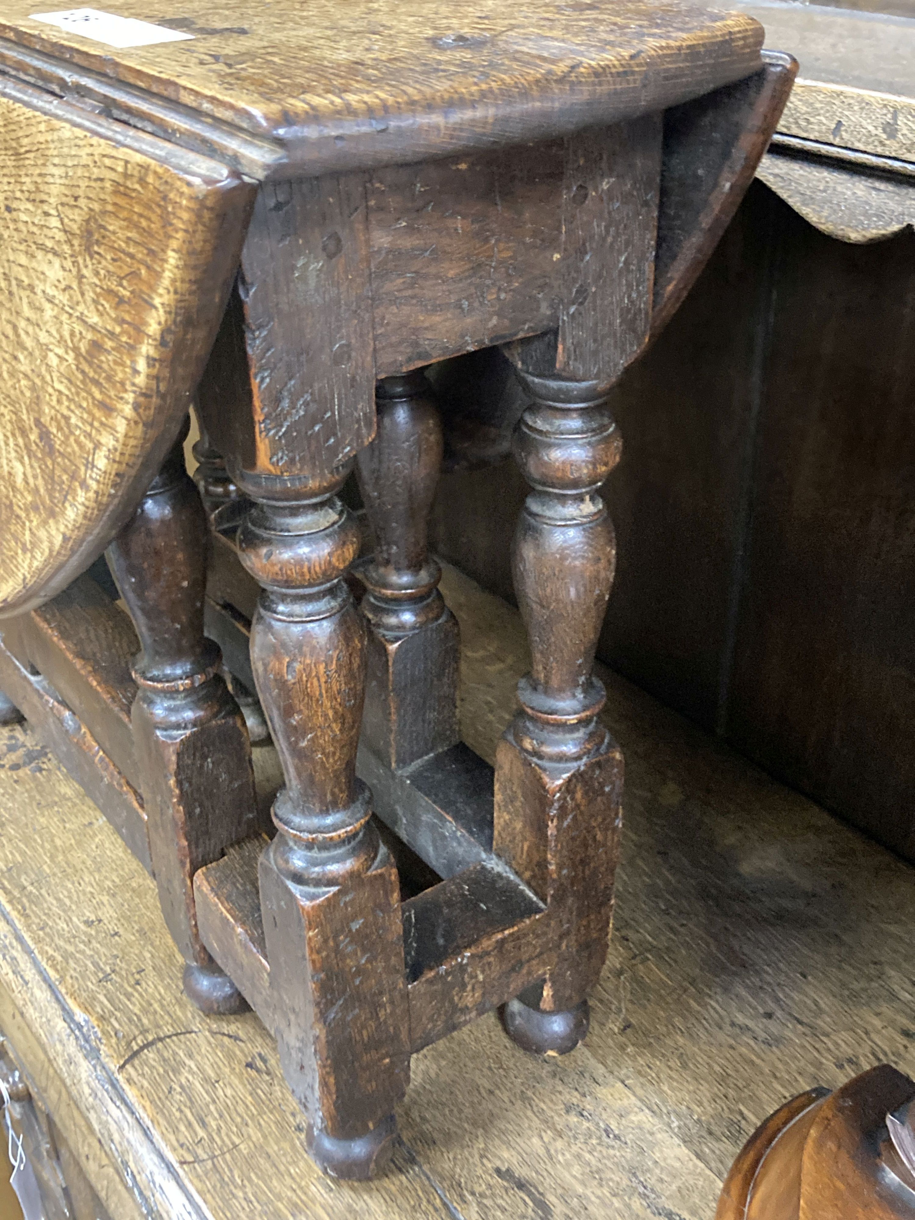 A 19th century miniature oak drop leaf gateleg table with turned supports, height 48cm, top 62 x 48cm